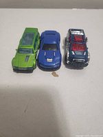 Top view of three toy cars showing colors and body styles