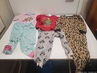 Overview of five clothing pieces laid out on table