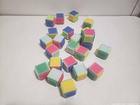 Group of multicolour bristle cube blocks on table