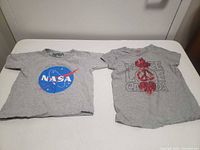 Front view of both grey kids t-shirts showing graphics