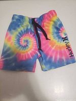 Front view of tie-dye Hurley swim shorts showing elastic waist, drawstring and logo