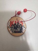 Front view showing KISS Kruise IV graphic and bead hanger