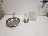 Pan, mug and container overview on table