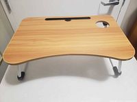 Top view of wood-grain lap desk showing tablet slot and cup holder cutout