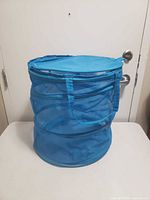 Front view of blue mesh collapsible laundry basket