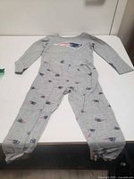 Front view of gray New England Patriots kids union suit pajamas