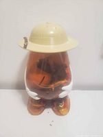 Front view of Mr. Potato Head container showing hat, arms, feet and contents