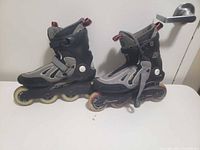 Side view of pair of K2 men’s inline skates showing boots, frame and wheels