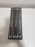 Spines of three black hardcover reference books in slipcase: Thesaurus, Dictionary, Concise Office Guide