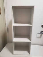 Full view of white 3-shelf bookcase front