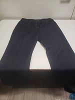 Full view of front of jeans laid flat