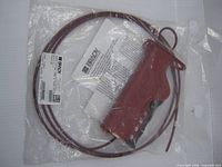 Front of sealed package showing lockout device and coiled cable