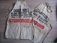 Both advertising aprons side by side showing overall condition and print