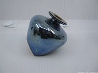 Front view squat iridescent blue vase