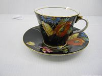 conical Aynsley teacup on saucer showing floral design and gilt details