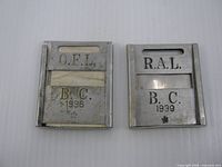 Front view of both licence holders showing dates and inscriptions