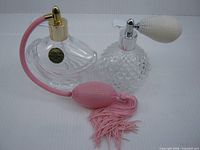 Both crystal perfume atomizers side by side showing overall design and bulbs