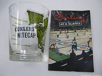 Front of Curlers Nitecap glass and Curling at a Glance booklet