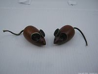 Front view of both teak mice showing ears, noses, eyes