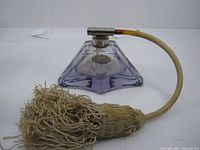 Side view of purple crystal perfume atomizer with tassel pump