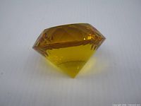 Side view of faceted amber crystal paperweight