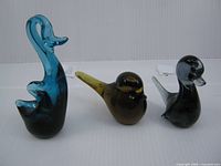 Group shot of three glass bird figurines