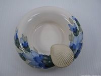 Top view showing floral pattern and shell handle