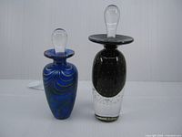 Front view of both perfume bottles with stoppers in place