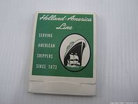 Front of green and white packet with Holland-America Line branding and ship graphic