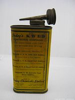 Front view of yellow Indag KWED tin with spout attached