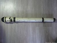 Full length view of telescope showing white painted body, black bands and eyepiece