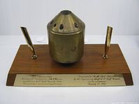 Full view of pen stand showing brass burner, pen holders, plaques on wood base