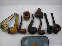 Group shot of all pipes, case and pouch