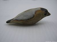 Left side profile of stoneware bird figurine