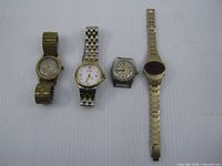 Group shot of four wristwatches laid out side by side