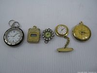 Group shot of five assorted watches lined up
