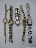 All five watches laid out side-by-side showing fronts and bracelets