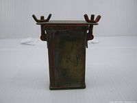 front view of metal match safe showing body and closure