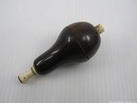 Side view displaying overall pear-shaped wooden body and finish