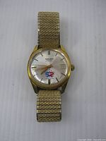 Front view of Gruen watch showing dial, logo, band