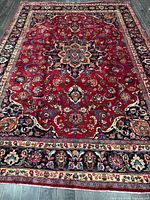 Full view of entire Mashhad Persian rug showing overall design and borders