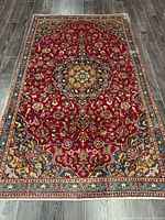 Full view of handmade Persian rug on floor
