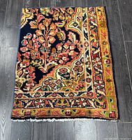 Full view of handmade wool rug showing overall design and fringe