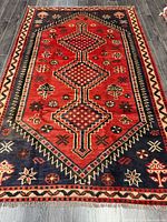 Full view of Shiraz rug showing overall design and border