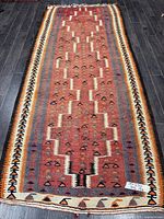 Full view of entire kilim runner showing design and size tag