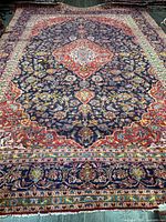 Full view of the Persian Kashan rug showing entire design and borders