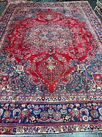 Full view of Mashhad rug showing complete pattern and borders