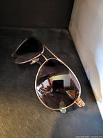 Front view of aviator sunglasses showing gold-tone frame and mirrored lenses