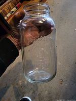 Full view of clear glass Bernardin Mason jar showing embossed branding and crest