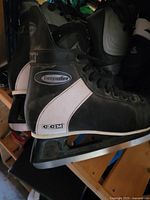 Side view of CCM Intruder ice hockey skates showing branding, boot condition, and blades